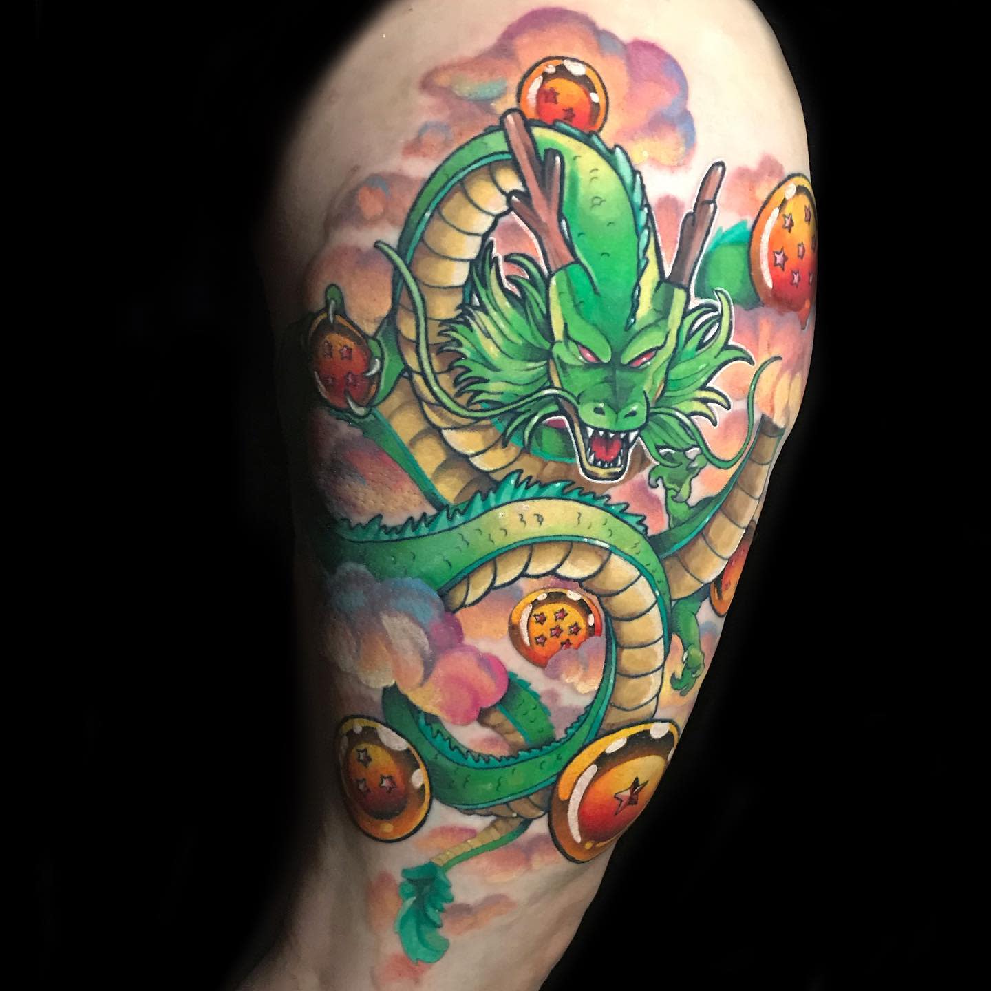 Bright and detailed Shenron tattoo on the arm, showcasing the dragon and Dragon Balls in a mystical cloud setting